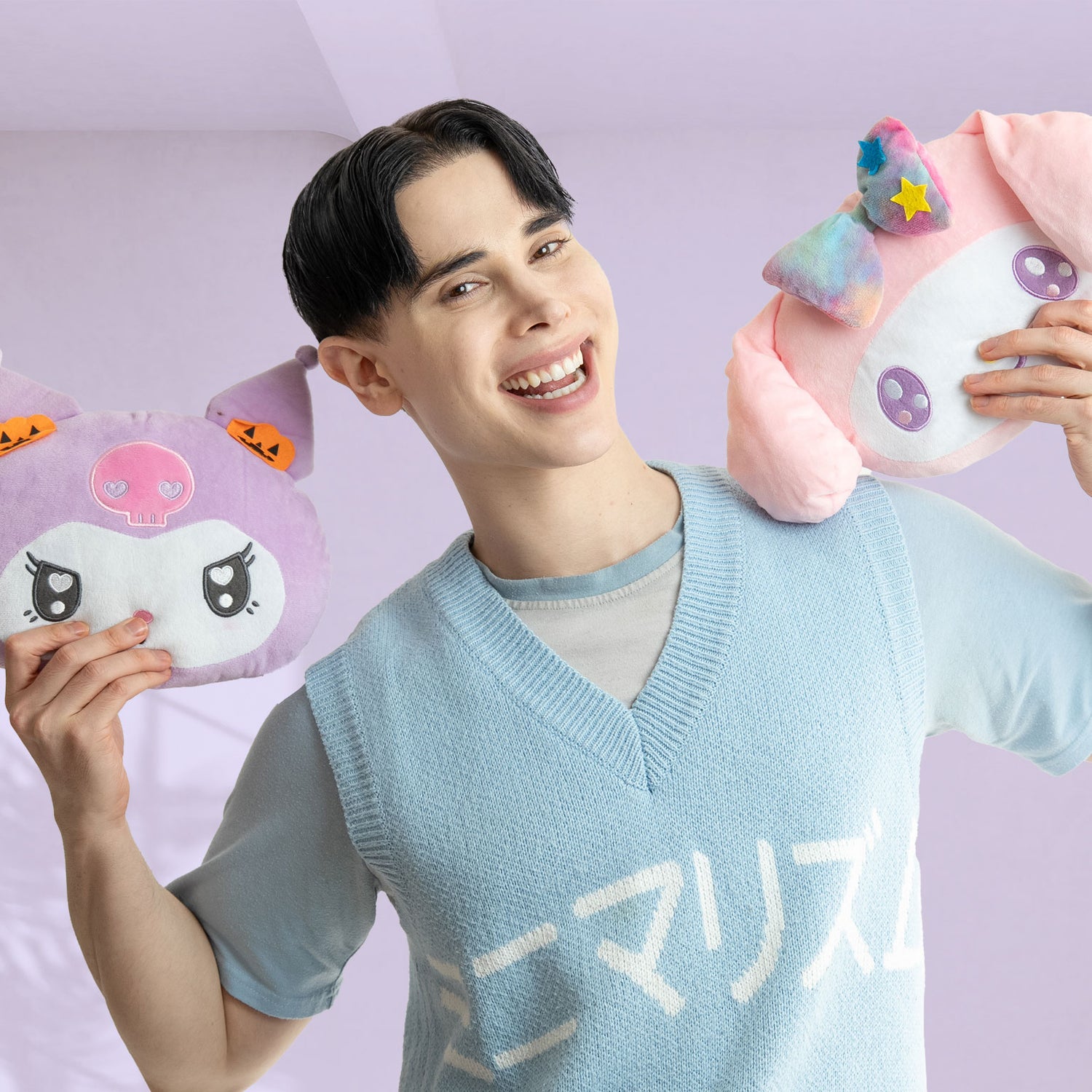 Person holding kawaii plush toys from japan against a light purple background